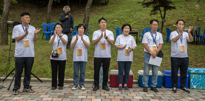 2025 한국입양인 평화대축제 운영위원인 파주시의원들이 행사 첫날인 13일 엄마 품 동산에 모인 입양인들에게 환영의 박수를 보내고 있다. 왼쪽부터 이익선, 이진아, 박은주, 손성익, 이혜정, 최창호, 최유각 의원이다. 사진 조영애 기자
