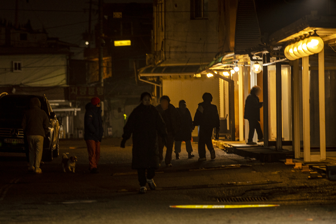 대기실을 커텐으로 가리거나 판넬로 막아 불빛을 차단했던 대추벌 성매매집결지가 불을 밝혔다. 파주시가 시민회관에서 연풍리 비전선포식을 한 16일 밤 업주들과 성노동자들이 업소를 돌며 청소를 함께 하는 등 준비를 하고 있다. 사진 이용남 선임기자